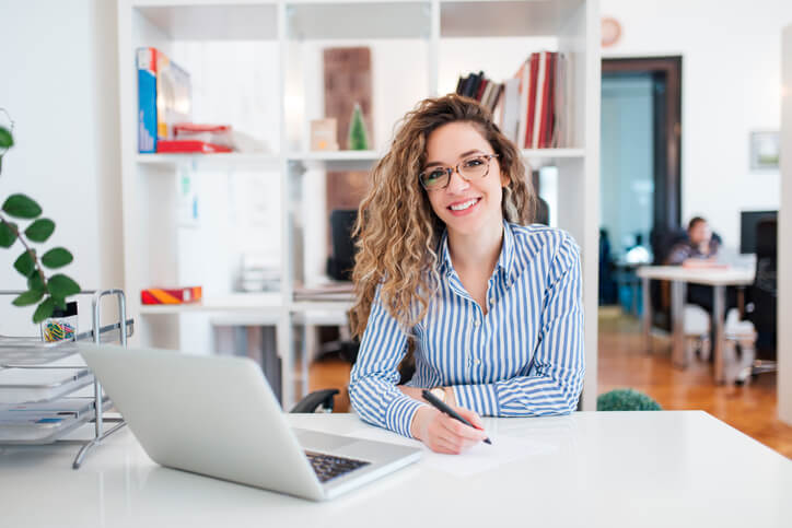 administrative assistant diploma graduate sitting at a desk