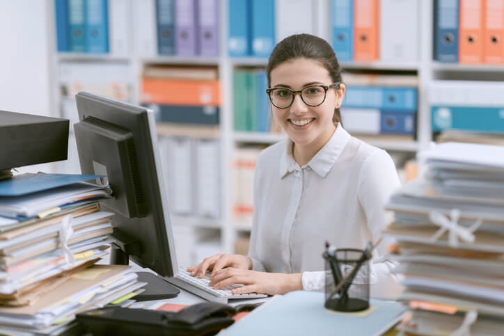 A career training graduate filing at a desk
