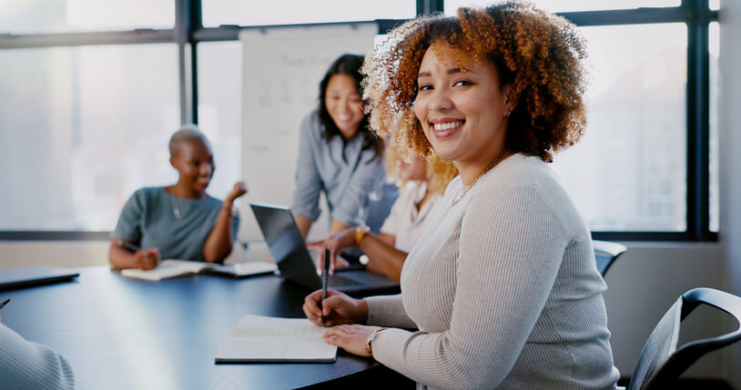 A smiling female professional undergoing business administration training at work