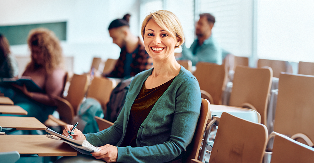 Adult learner engaging in a classroom discussion with peers, representing career growth and lifelong learning.